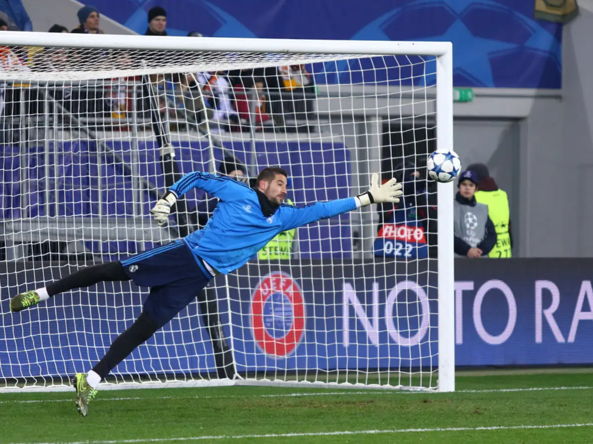 A keeper trying to save a ball