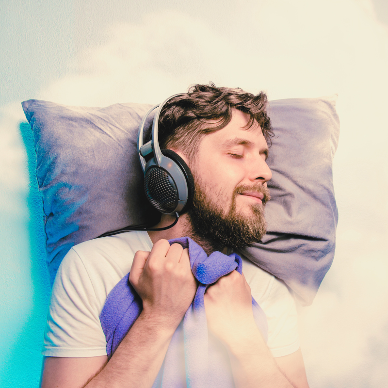 A person sleeps with headphones on football4football