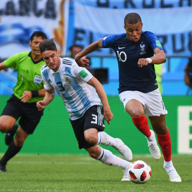 Mbappe dribbles with the ball past a defender football4football